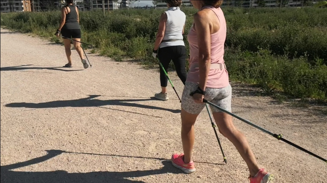 Grupo de tres personas caminando con bastones
